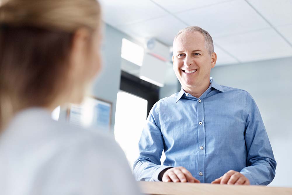 Man smiling at patient in doctor's office